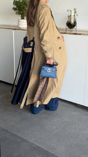 Beige linen trench coat with navy back panel and plaid details