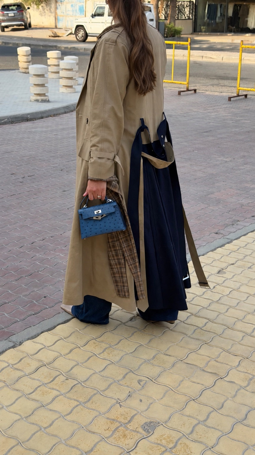 Beige linen trench coat with navy back panel and plaid details