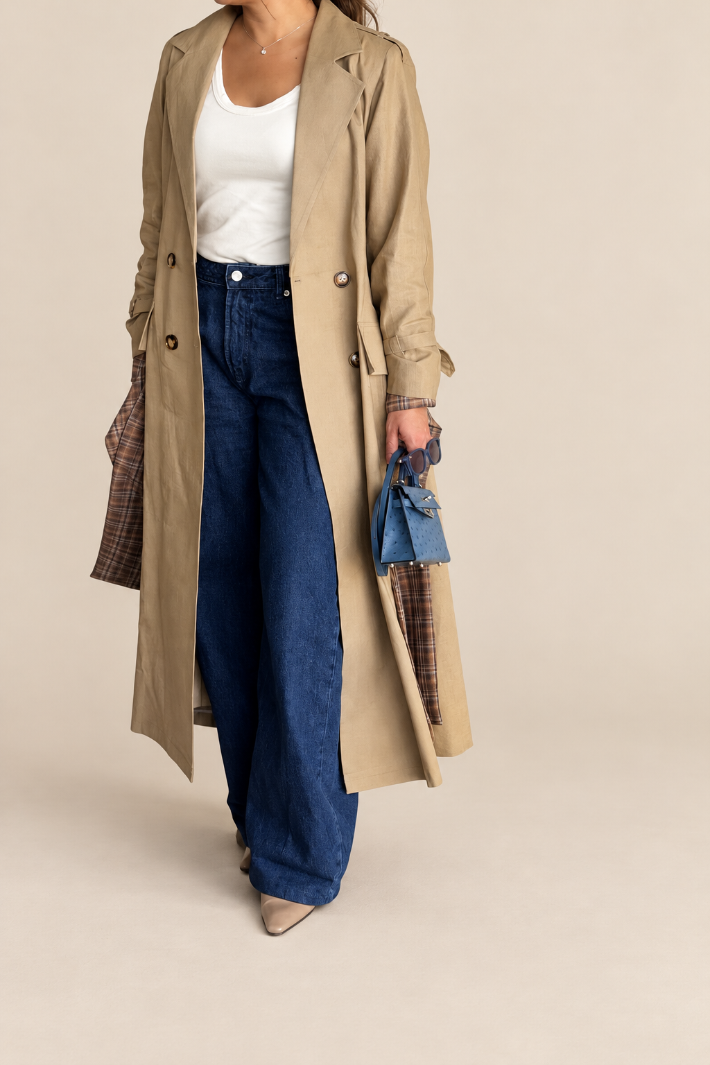 Beige linen trench coat with plaid details on a plain beige background