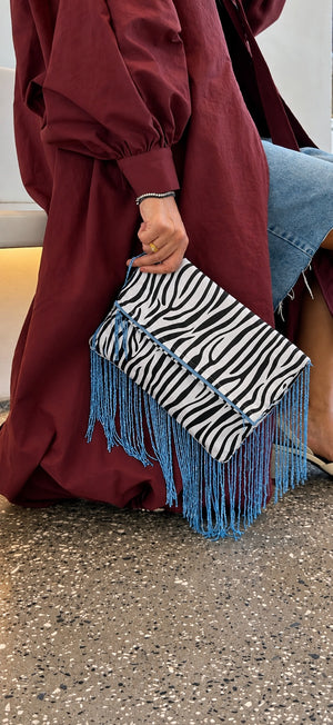 Zebra Affair zebra print clutch with turquoise fringe