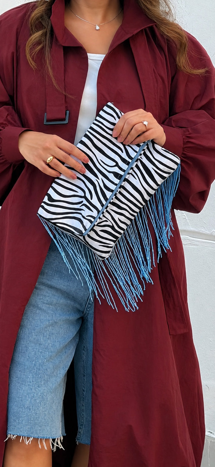 Zebra Affair zebra print clutch with turquoise fringe