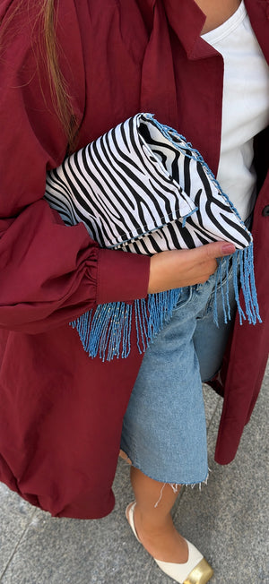 Zebra Affair zebra print clutch with turquoise fringe